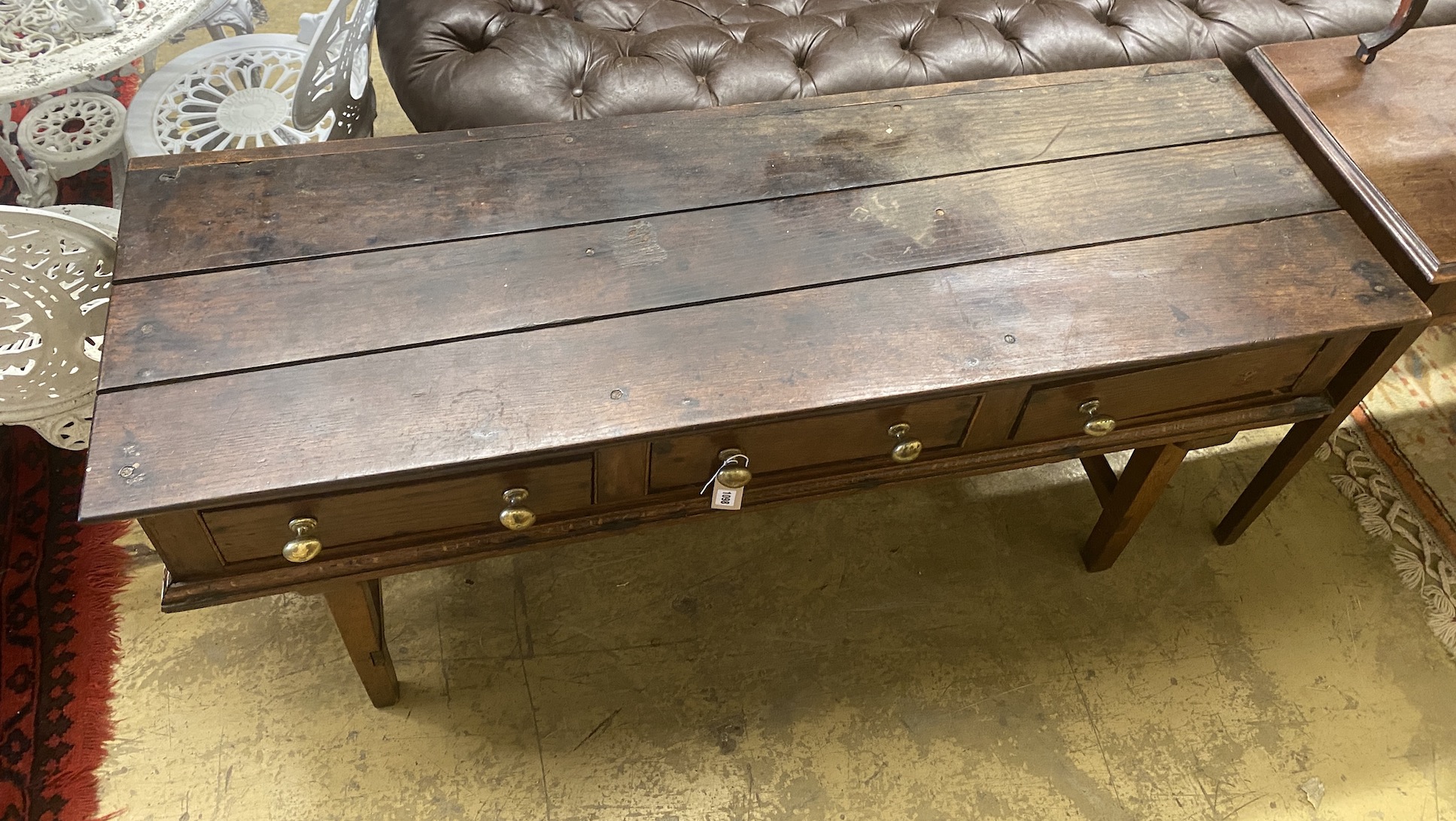 An 18th century oak low dresser on later square tapered legs, width 150cm, depth 50cm, height 70cm